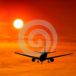 Silhouetted commercial airplane flying