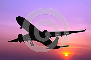 Silhouetted commercial airplane flying