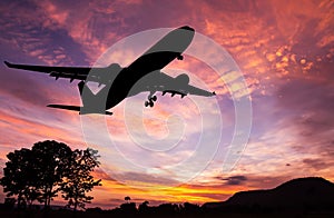 Silhouetted commercial airplane flying