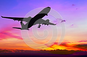 Silhouetted commercial airplane flying