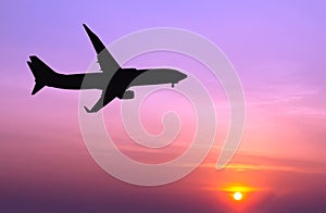Silhouetted commercial airplane flying