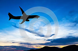 Silhouetted commercial airplane flying