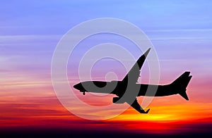 Silhouetted commercial airplane flying