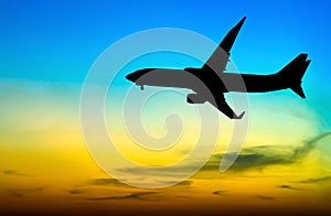 Silhouetted commercial airplane flying