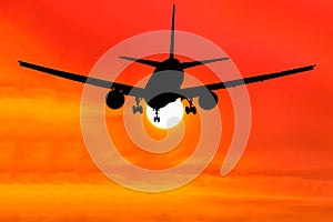 Silhouetted commercial airplane flying