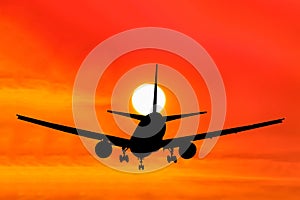 Silhouetted commercial airplane flying