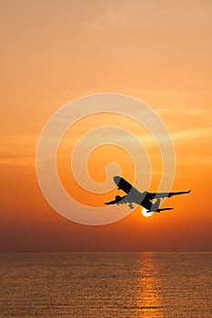 Silhouetted commercial airplane flying