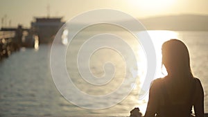 Silhouetted couple hold each other and kiss on the beach. date on the seafront