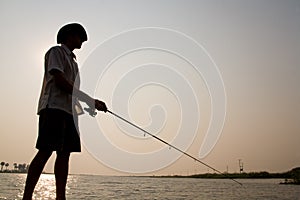 Silhouetted fisherman photo