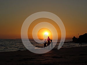 Silhouetted Kids at Sunset, Beach - Summer - Fun