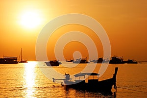 Silhouetted longtail boat at sunrise on Ao Ton Sai, Phi Phi Don Island, Krabi Province, Thailand