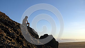 Silhouetted man on beach