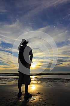 Silhouetted man on beach