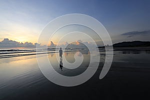 A silhouetted man at a beach
