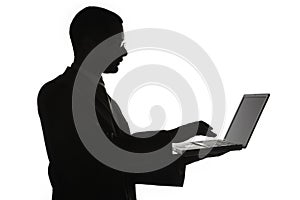 Silhouetted man with laptop