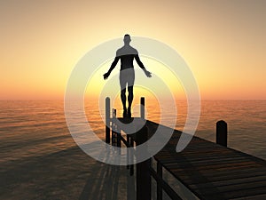 Silhouetted man on pier