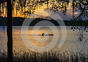 Silhouetted man rows through pond in Payne`s Prairie.CR2 photo