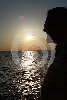 Silhouetted man and sea