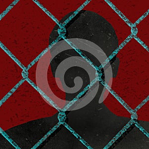 A silhouetted man is seen behind chainlink fence