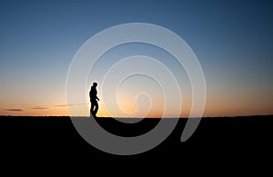 Silhouetted man in sunset