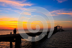 Silhouetted of people on the bridge