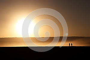 Silhouetted people at the sunset