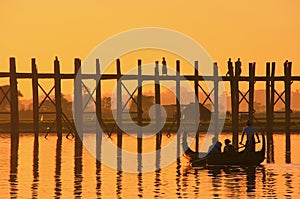 Silhouetted people on U Bein Bridge at sunset, Amarapura, Myanmar