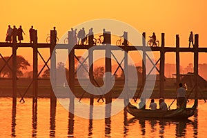 Silhouetted people on U Bein Bridge at sunset, Amarapura, Myanmar