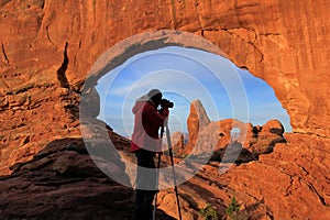 Silhouetted person photographing North Window and Turret Arch, A