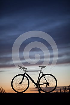 Silhouetted race bike in sunset photo