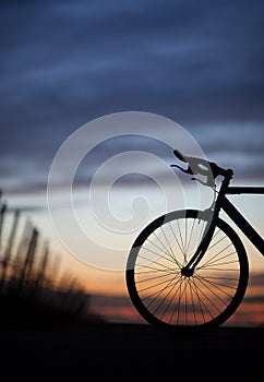 Silhouetted race bike in sunset photo