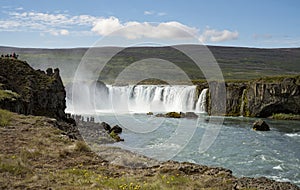 Silhouetted Tourists Viewing the Dramatic Godafoss Waterfall in Iceland