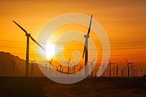 Silhouetted Wind Turbines Over Dramatic Sunset Sky