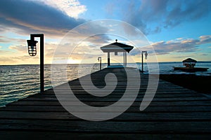 Silhouetted wooden pier