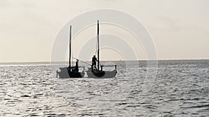 Silhouettes African Wooden Dhow Boat with Fishermen Floating by Ocean, Zanzibar
