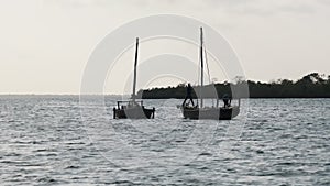 Silhouettes African Wooden Dhow Boat with Fishermen Floating by Ocean, Zanzibar