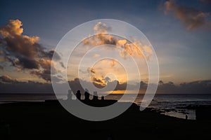 Silhouettes of Ahu Tahai moai in Hanga Roa, Easter Island during sunset