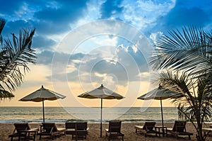 Silhouettes of beach umbrellas sunset and sky