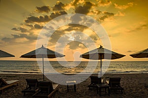 Silhouettes of beach umbrellas sunset and sky