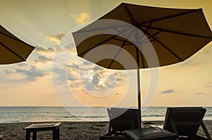 Silhouettes of beach umbrellas sunset and sky