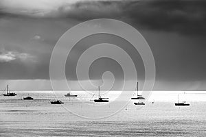 Silhouettes of boats under the dark stormy sky