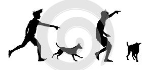 Silhouettes of a boy playing with his dog