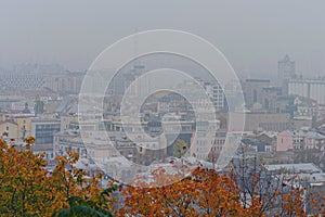 Silhouettes of buildings in the Podil district in sick fog. The rooftops of buildings