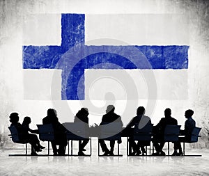 Silhouettes of Business People and a Flag of Finland