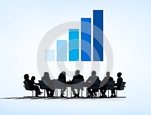 Silhouettes of Business People Having a Meeting and Graph Above