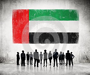 Silhouettes of Business People Looking at the Flag of UAE