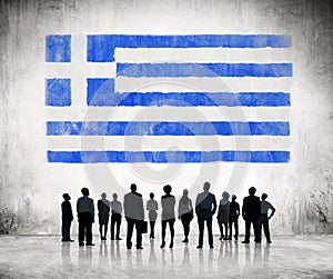 Silhouettes of Business People Looking at the Greek Flag