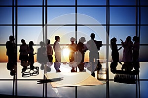 Silhouettes of Business People Working in Board Room