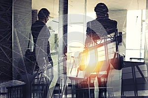 Silhouettes of businessman at the airport who waits for boarding. Double exposure.