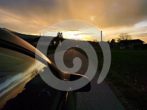 Silhouettes of a car while the sunset